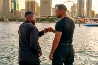 Martin Lawrence and Will Smith bump their fists overlooking the Miami skyline.